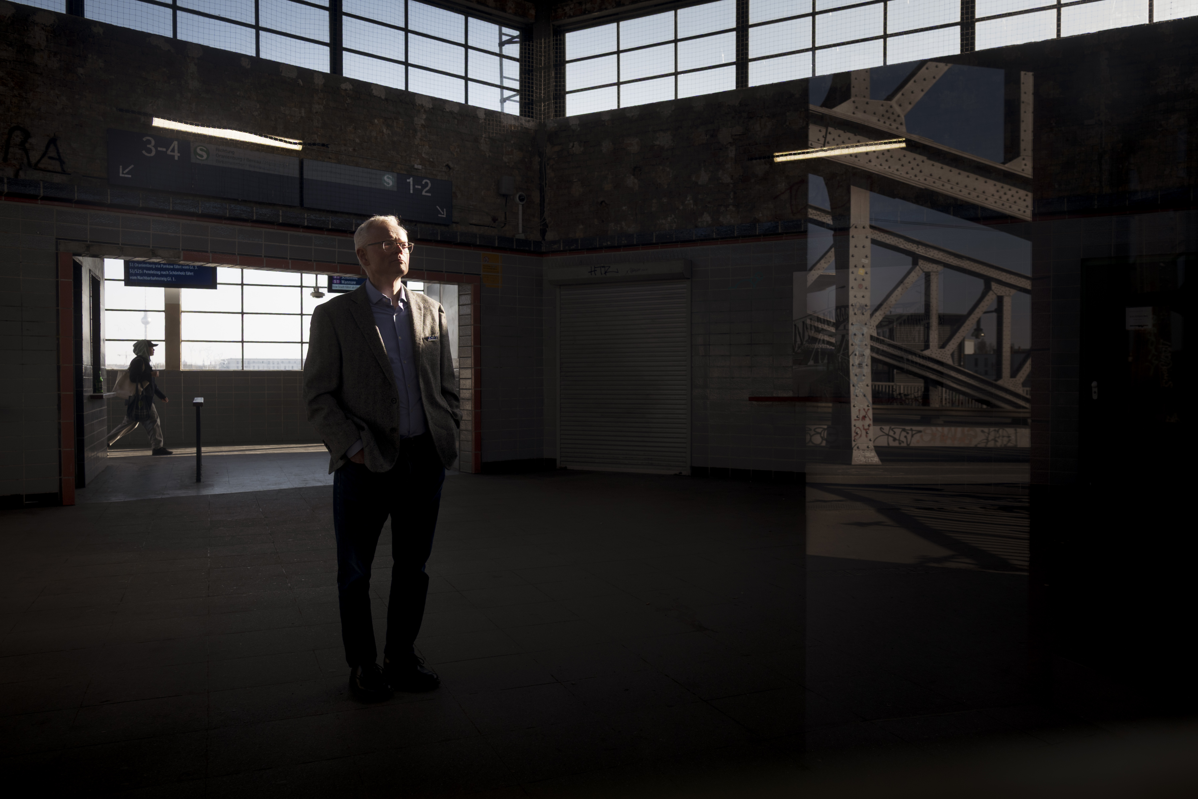 Ian Johnson stands inside the S-Bahn station Bornholmer Straße