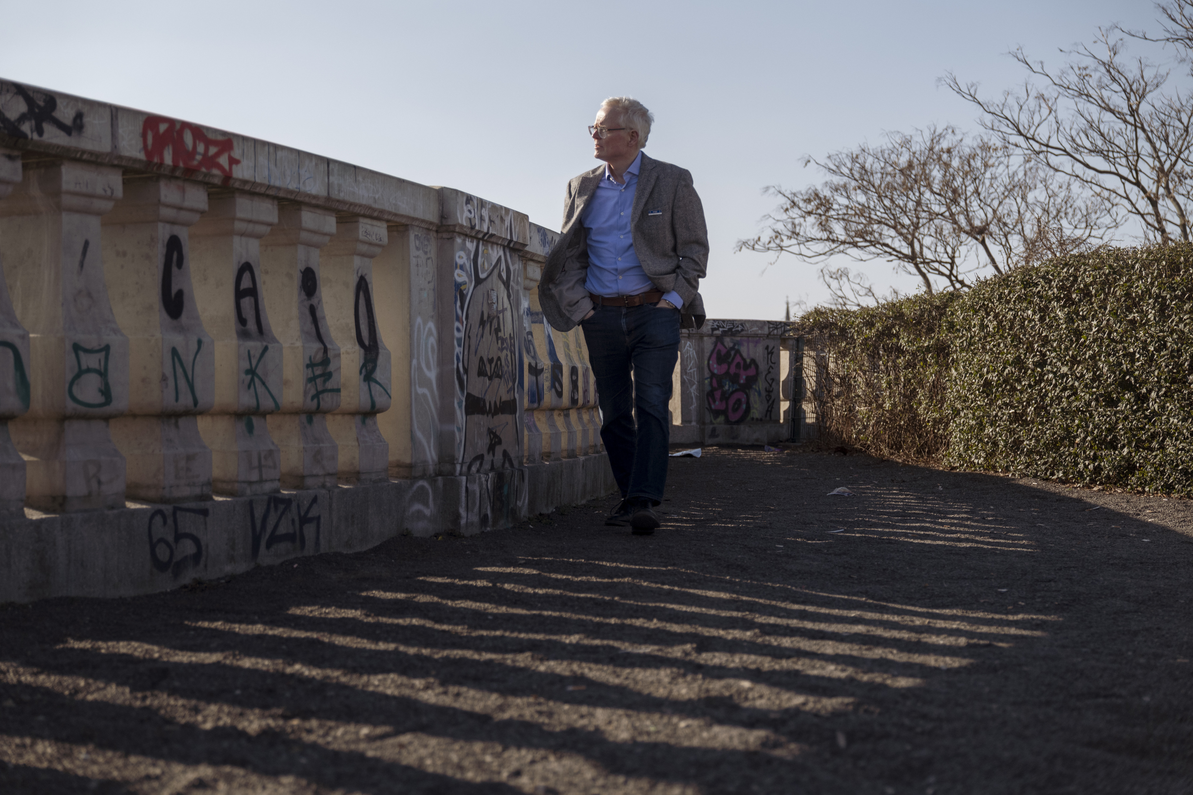 Ian Johnson walks next to a wall